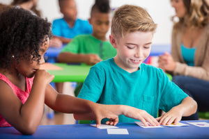 Stock image photo of children playing educational card games
