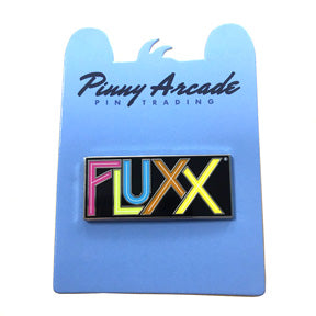 Photo of ourFlux Logo Pin attached to a blue cardboard backer that says Pinny Arcade