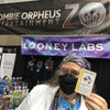 Photo of Kristin holding a Zombie Portal card in a trade show booth